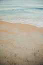 Blue ocean wave on sandy beach. Beautiful soft waves of the sea. Summer nature background. Sea shells are lying on the Royalty Free Stock Photo