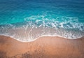 Blue ocean waves hits the shoreline. Beautiful texture of turquoise sea water and golden sandy beach. Tropical summer seaside