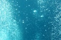 Blue ocean waves from underwater with bubbles. Light rays shining through. Great for backgrounds Royalty Free Stock Photo