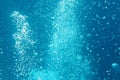 Blue ocean waves from underwater with bubbles. Light rays shining through. Great for backgrounds Royalty Free Stock Photo