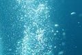 Blue ocean waves from underwater with bubbles. Light rays shining through. Great for backgrounds Royalty Free Stock Photo