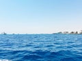 Blue ocean with yachts and distant shoreline Royalty Free Stock Photo