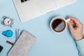 Blue Office desk of Business workplace. Woman hands with laptop, spectacles and coffee cup. Top view. Flat lay Royalty Free Stock Photo