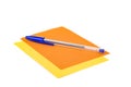 Blue office pen on blank orange and yellow layered note pad pages isolated over white Royalty Free Stock Photo