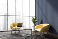 Blue office seating area with two yellow armchairs Royalty Free Stock Photo