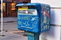 Blue official french public mail box with colorful paintings in coty street