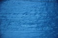 Blue oil paint texture with spots and streaks on wooden surface Royalty Free Stock Photo
