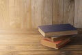 Blue old books The red on the old wooden table, the background of the old wood wall and the soft sunlight shines There is a Royalty Free Stock Photo