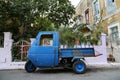 A blue old little pickup truck in the street by the old stone houses in Calymnos Island Royalty Free Stock Photo