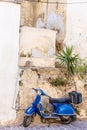 Blue old scooter parked by the wall in the empty street Chania Crete Royalty Free Stock Photo