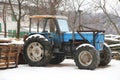 Blue old tractor on a farm in winter Royalty Free Stock Photo