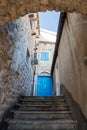 Blue old wooden door in a stone house with stairs Royalty Free Stock Photo