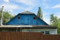 Blue old wooden loft of a rural house with a door and small windows Royalty Free Stock Photo