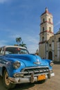 Blue classic Chevrolet parked in the central square in Remedios