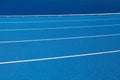 Blue Olympic track lanes with white stripes, an empty background suitable for copy space, represent the concept of physical sports Royalty Free Stock Photo