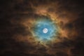 Blue Ominously Moon lights through the clouds. Night Sky Sunflower Royalty Free Stock Photo