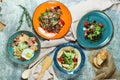 Multi-colored plates with different salads. Beautiful serving of dishes. Light gray background. Restaurant menu Royalty Free Stock Photo