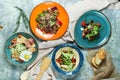 Multi-colored plates with different salads. Beautiful serving of dishes. Light gray background. Restaurant menu Royalty Free Stock Photo