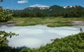 A blue opaque thermal lake in the caldera of an extinct volcano.