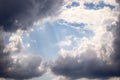 Blue open sky with dark and white clouds and light beams Royalty Free Stock Photo