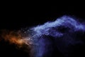 Blue orange color powder explosion on black background Royalty Free Stock Photo