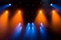 Blue and orange rays of light through the smoke on stage. lighting equipment. Spotlight Royalty Free Stock Photo