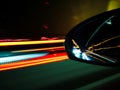 Neon lanes and car's reflection in rear view mirror Royalty Free Stock Photo