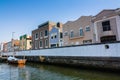 blue and orange rowing boat on the canal in Aveiro, Portugal. traditional houses on the waterfront along the canal Royalty Free Stock Photo