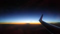 Blue orange sunset from a sky height. Airplane wing