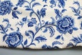 Blue ornate floral pattern on white cotton tablecloth Royalty Free Stock Photo