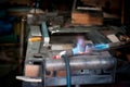 Blue oxygen flames melting steel on a workbench. Metal welding