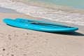 Blue Paddle Boat And Oar On Shoreline Of Tropical Beach