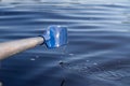 The blue paddle from the boat was rowing the water Royalty Free Stock Photo