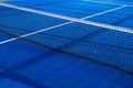 Blue paddle tennis net and court field background Royalty Free Stock Photo