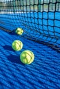 blue paddle tennis court with three balls near the net Royalty Free Stock Photo