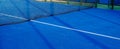 Blue paddle tennis net and court field background Royalty Free Stock Photo