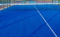 Blue paddle tennis net and court field background Royalty Free Stock Photo