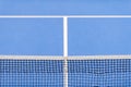 Blue paddle tennis net and hard court Royalty Free Stock Photo