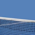 Blue paddle and tennis net and hard court. Professional sport and tennis competition concept Royalty Free Stock Photo