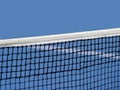 Blue paddle and tennis net and hard court. Professional sport and tennis competition concept Royalty Free Stock Photo