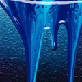 Blue paint drips down a textured surface, creating a dynamic Royalty Free Stock Photo