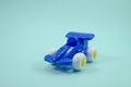 Blue paint plastic toy racing car with number three isolated on turquoise Royalty Free Stock Photo