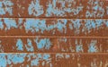 Blue paint rests on rusty structure