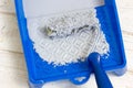 Blue paint tray with paint roller and paint inside it. Royalty Free Stock Photo