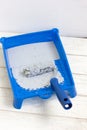 Blue paint tray with paint roller and paint inside it. Royalty Free Stock Photo