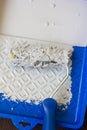 Blue paint tray with paint roller and paint inside it. Royalty Free Stock Photo