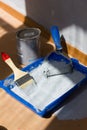 Blue paint tray with paint roller and brush inside it. Royalty Free Stock Photo