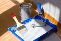 Blue paint tray with paint roller and brush inside it. Royalty Free Stock Photo