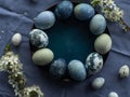 Blue painted easter eggs with cherry blossom twigs