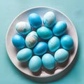 Blue painted eggs arranged on plate, top view Easter composition Royalty Free Stock Photo